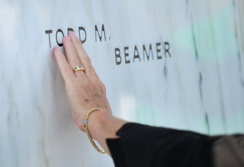 A woman runs her hands along a name of one of the victims of the United flight 93 crash at the Flight 93 National Memorial on the tenth anniversary of the 9/11 terrorist attacks, on Sept. 11, 2011 in Shanksville, Pa. The Flight 93 Memorial honors the victims of United flight 93 which crashed in Shanksville after the passangers fought back against the hijackers. The plane, which was believed to be headed to a target in Washington was downed in the field. UPI/Kevin Dietsch