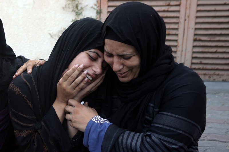 People mourn during a funeral for Palestinians killed in Israeli shelling in Khan Younis, in the southern Gaza Strip, on October 10. File Photo by Ismael Mohamad/UPI