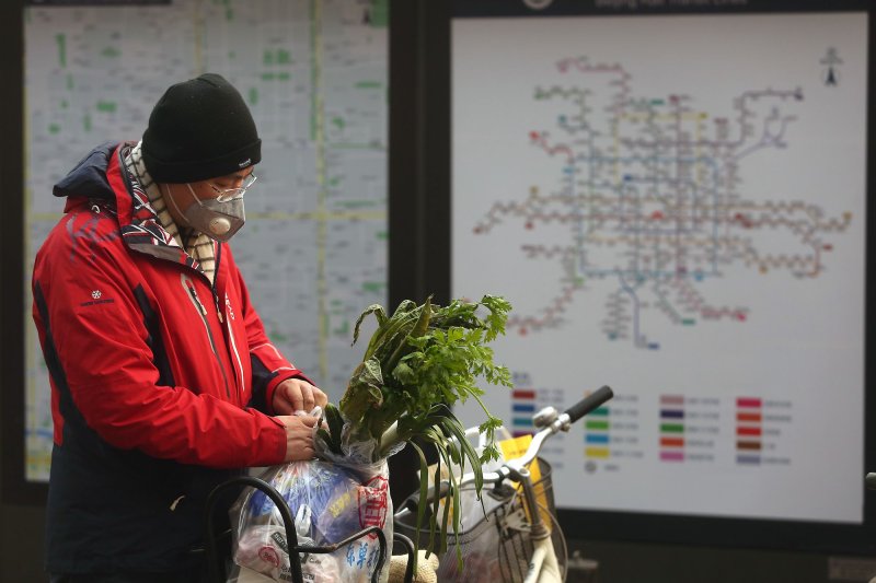 A Chinese man wears a protective face mask while shopping due to the threat of the deadly coronavirus in Beijing on Thursday. Photo by Stephen Shaver/UPI