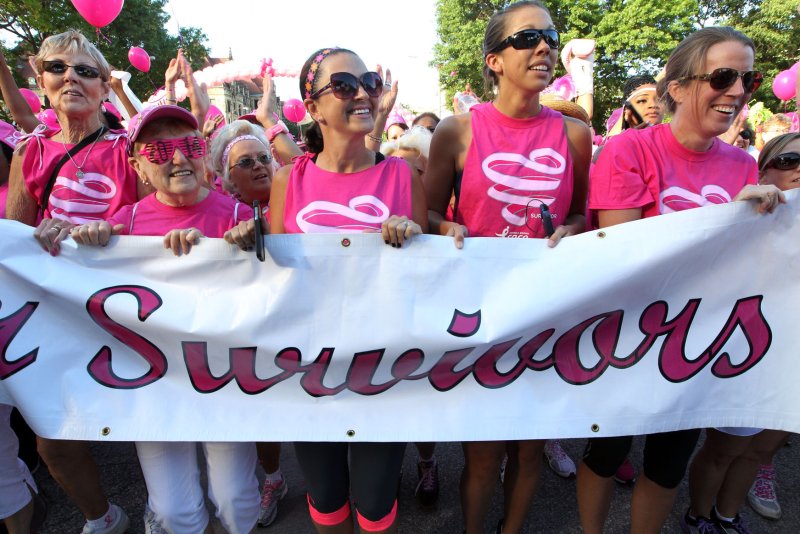 Breast cancer survivors march up to the stage during a special ceremony before the start of the annual Koman Race for the Cure in St. Louis on June 14, 2014. UPI/Bill Greenblatt