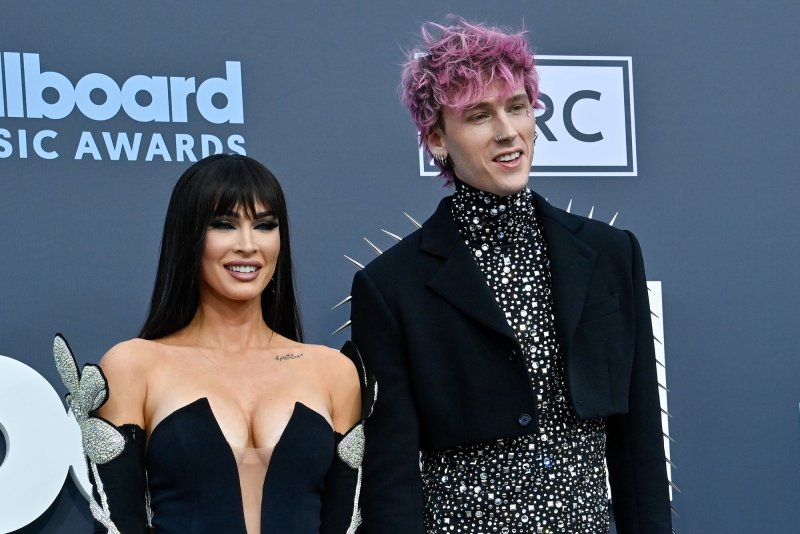 Machine Gun Kelly (R), pictured with Megan Fox, is the subject of the new documentary "Machine Gun Kelly's Life in Pink." File Photo by Jim Ruymen/UPI