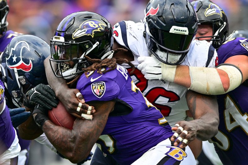Baltimore Ravens running back Gus Edwards (C) is stopped by Houston Texans defensive tackle Maliek Collins on Sunday at M&amp;T Bank Stadium in Baltimore. Photo by David Tulis/UPI