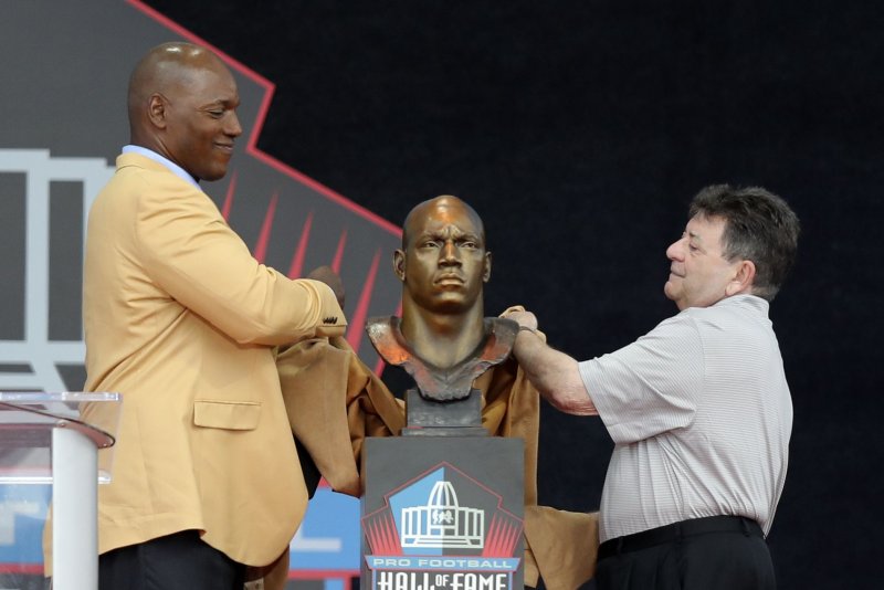 Former San Francisco 49er, Bryant Young, unveils his bust with the help of San Francisco 49ers owner, Ed DeBartolo Jr, as he is inducted into the Pro Football Hall of Fame in Canton, Ohio, on Saturday, August 6, 2022. Photo by Aaron Josefczyk/UPI | <a href="/News_Photos/lp/c0a2313418294afb6e3ec9bf96773dee/" target="_blank">License Photo</a>