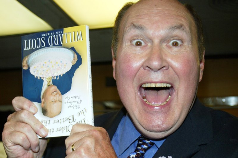 Willard Scott signs copies of his new book "The Older the Fiddle the Better the Tune" at Barnes &amp; Noble, 5th Avenue, New York on May 15, 2003. Scott died on Saturday. File Photo by Laura Cavanaugh/UPI
