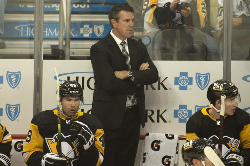Pittsburgh Penguins head coach Mike Sullivan (C), shown Oct. 16, 2021, missed Thursday night's game against the Philadelphia Flyers after the positive test result. File Photo by Archie Carpenter/UPI