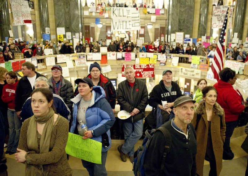 Protesters watch a live feed of a state assembly session as members vote to engross controversial legislation at the state Capitol in Madison, Wisconsin on February 24, 2011. The legislation, proposed by Republican Gov. Scott Walker, includes cuts in benefits for state workers and takes away many of their collective bargaining rights. UPI/Brian Kersey