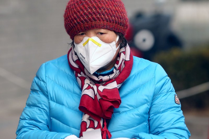 A Chinese woman wears a protective face mask at a shopping center due to the threat of the spreading deadly coronavirus in Beijing. Photo by Stephen Shaver/UPI