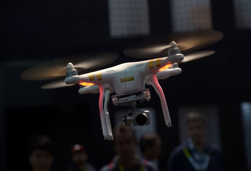 The DJI Phantom 3 Professional drone flies at the at the 2016 International CES, a trade show of consumer electronics, in Las Vegas, Nev., January 7, 2016. An Australian drone pilot faces a fine of up to $9,000, as the Civil Aviation Safety Authority is investigating a video of him using a drone to deliver a sausage from a local hardware retail chain to a man in a hot tub. Photo by Molly Riley/UPI