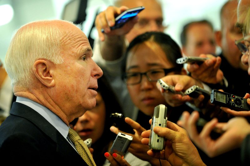 Sen. John McCain (R-AZ) talks to reporters as he walks to the Senate Chambers for the ongoing debate on the Senate's immigration reform bill, on Capitol Hill in Washington, D.C. on June 20, 2013. UPI/Kevin Dietsch