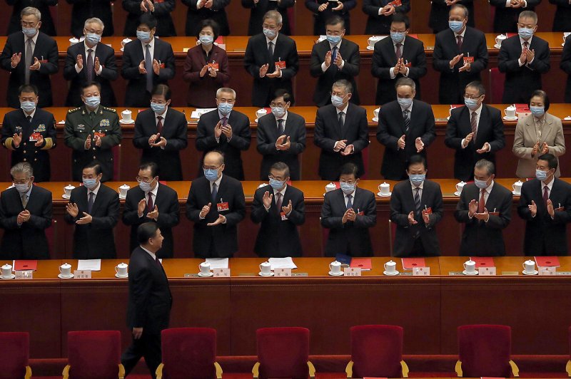Chinese President Xi Jinping is applauded by top leaders as he arrives for the closing Fourth Session of the 13th National People's Congress (NPC) being held in the Great Hall of the People In Beijing on March 11 when a draft decision to overhaul Hong Kong's electoral system was approved. Photo by Stephen Shaver/UPI
