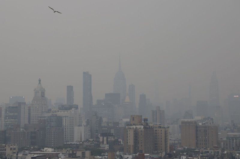 Several states, including New York, are facing unhealthy air conditions Tuesday under the haze produced by Canadian wildfires while dry conditions are raising more fire concerns. The Manhattan skyline is barely visible hours before sunset on Tuesday as it is enveloped in smoke from the fires. Photo by John Angelillo/UPI