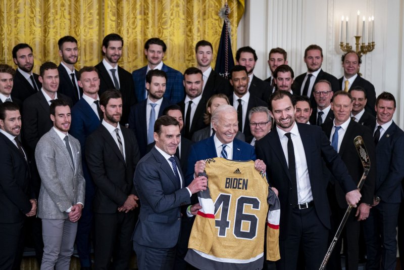 President Joe Biden is presented a jersey and hockey stick by George McPhee, president of hockey operations for the Vegas Golden Knights, and team captain Mark Stone at the White House on Monday while celebrating the squad's 2023 Stanley Cup victory. Photo by Al Drago/UPI