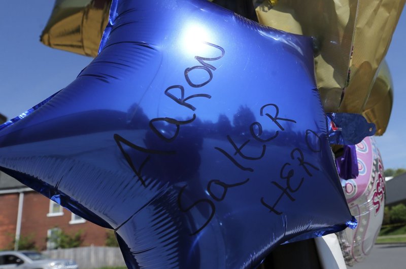 A balloon honors retired Buffalo, N.Y., police officer Aaron Salter on May 15 near the site of a mass shooting at a supermarket. Salter was working at the supermarket as a security guard and was killed as he confronted the gunman. Photo by Aaron Josefczyk/UPI | <a href="/News_Photos/lp/6fde9582f09bd9ddcff88de7712f86a3/" target="_blank">License Photo</a>