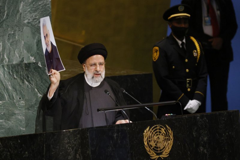 Iranian President Ebrahim Raisi holds up a photo of deceased Maj. Gen. Qassim Suleimani, during his speech at the United Nations General Assembly in New York City on Wednesday. Photo by John Angelillo/UPI | <a href="/News_Photos/lp/e29f0f0aec2bd08210b16adf84d41a2c/" target="_blank">License Photo</a>