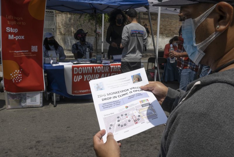 A volunteer hands out leaflets offering monkeypox vaccinations at a fetish and leather festival on Folsom Street in San Francisco on July 31. On Monday, Wyoming confirmed its first case of monkeypox, meaning the outbreak as spread to all 50 U.S. states. File Photo by Terry Schmitt/UPI