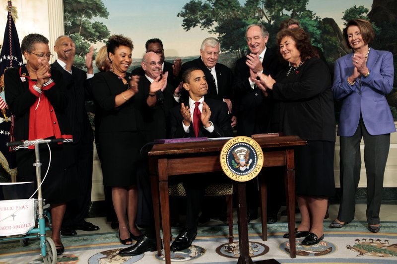 U.S. President Barack Obama, surrounded by members of Congress and Jeanne White-Ginder, mother of Ryan White (2nd R), signs the Ryan White HIV/AIDS treatment extension act of 2009 in the Diplomatic Room of the White House in Washington on October 30, 2009. The act was named in honor of Ryan White, a teenager who contracted AIDS through a tainted hemophilia treatment in 1984 and became a well-known advocate for AIDS research and awareness, until his death on April 8, 1990. UPI File Photo