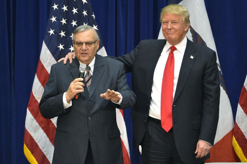Presumptive Republican presidential nominee Donald Trump, right, stands with Maricopa County Sheriff Joe Arpaio during a campaign event in Iowa in January. Arpaio is an outspoken critic of the nation's immigration policy and has been the target of protests for his crackdown on illegal immigrants in the Phoenix area for years. File Photo by Mike Theiler/UPI