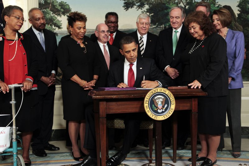 U.S. President Barack Obama, surrounded by members of Congress and Jeanne White-Ginder, mother of Ryan White (2nd R), signs the Ryan White HIV/AIDS treatment extension act of 2009 in the Diplomatic Room of the White House in Washington on October 30, 2009. The act was named in honor of Ryan White, a teenager who contracted AIDS through a tainted hemophilia treatment in 1984 and became a well-known advocate for AIDS research and awareness, until his death on April 8, 1990. UPI File Photo