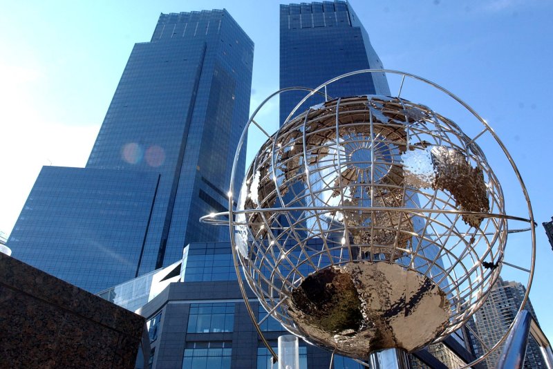 The globe from Trump Plaza Hotel frames the twin skyscrapers of theTime Warner Center in New York. The company announced Wednesday a 10 percent ownership stake in Hulu. File photo by Ezio Petersen/UPI