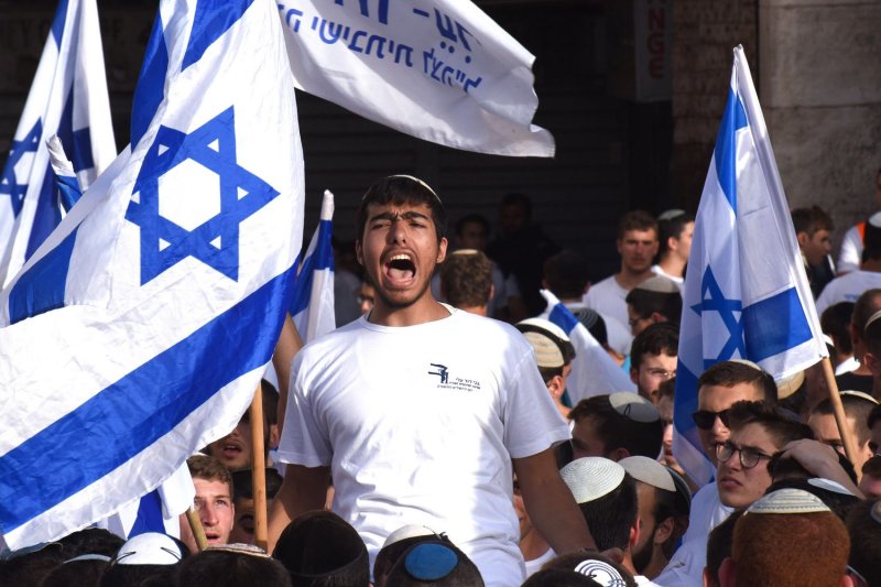 Jewish right-wing extremists carry Israeli flags during the controversial 'Flag March' outside the Damascus Gate of Jerusalem's Old City in East Jerusalem on Sunday. Photo by Debbie Hill/UPI | <a href="/News_Photos/lp/c1c8e6024b94b46a58957be9b93ad25d/" target="_blank">License Photo</a>