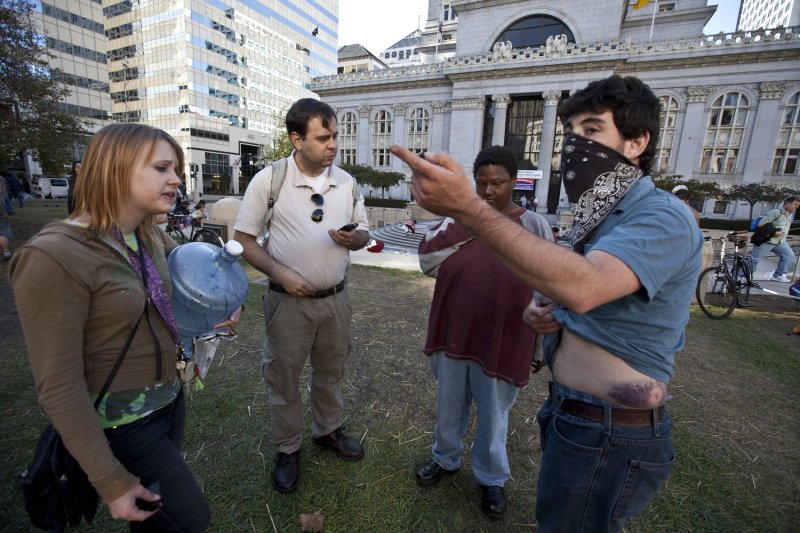Occupy Oakland protester Shamus Collins explains to others how he was shot with a rubber bullet as he went to the aid of injured Iraqi war veteran Scott Olsen at a new encampment in Frank H. Ogawa Plaza in Oakland, California on October 27, 2011. Olsen suffered serious head injuries after being hit by a projectile fired by police during the Occupy Oakland protests. UPI/Terry Schmitt