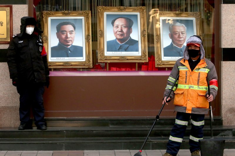 Chinese workers wear protective face masks in Beijing, China, on Wednesday, to guard against the coronavirus. Photo by Stephen Shaver/UPI | <a href="/News_Photos/lp/1d2c9273ab17f9f8a4893b2bd1df60b3/" target="_blank">License Photo</a>