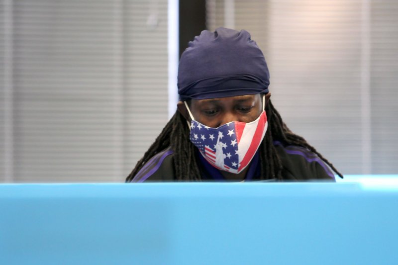 A voter wearing an American flag mask casts a ballot during the November 3 general election at a polling place in Lawrenceville, Georgia. File photo by Tami Chappell/UPI