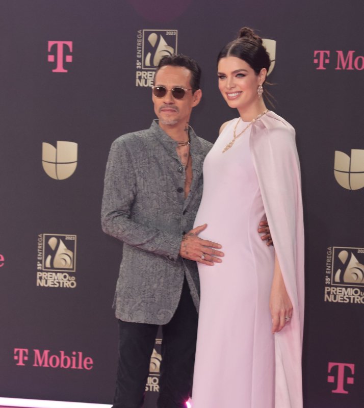 Marc Anthony (L) and Nadia Ferreira attend the Premio Lo Nuestro awards on Thursday. Photo by Gary I. Rothstein/UPI