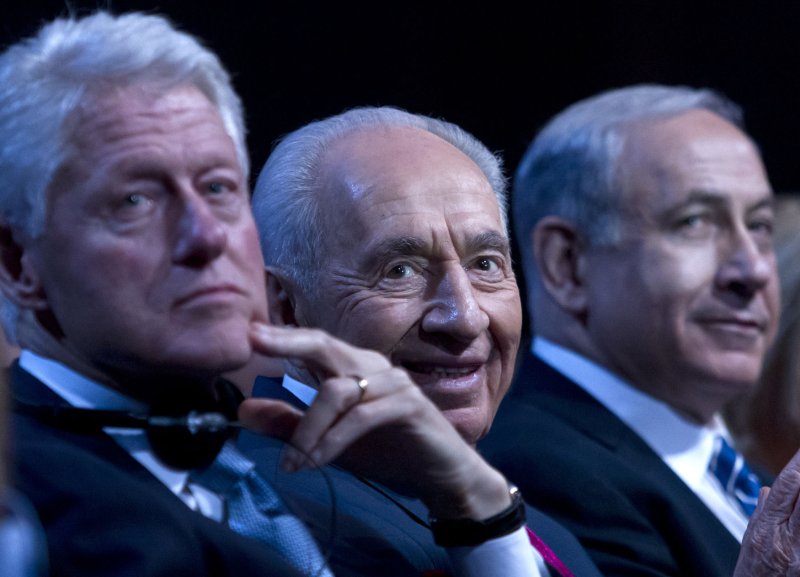 Israeli President Shimon Peres (C ) sits with US President Bill Clinton and Israeli Prime Minister Benjamin Netanyahu (R ) during his 90th birthday gala in Jerusalem on June 18, 2013. UPI/Jim Hollander/Pool