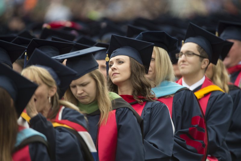 A new poll shows college graduates who got a good job upon graduation earned more to pay off college debt. File Photo by Molly Riley/UPI