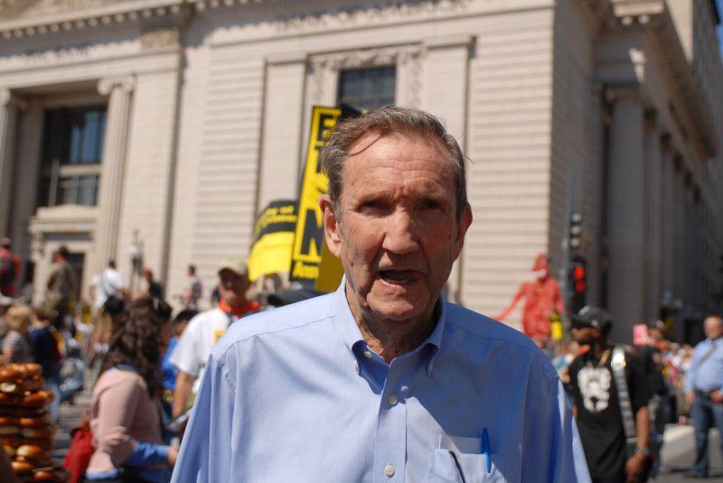 Former U.S. Attorney General Ramsey Clark walks on Pennsylvania Avenue as thousands of protesters gather nearby to demonstrate against the Iraq War in Washington on September 15, 2007. File Photo by Alexis C. Glenn/UPI