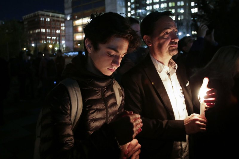 Mourners hold candles at a vigil to honor the terror attack victims in New York on Thursday. Photo by John Angelillo/UPI | <a href="/News_Photos/lp/570ccf1a6d23dc1c6d717ab641e29885/" target="_blank">License Photo</a>