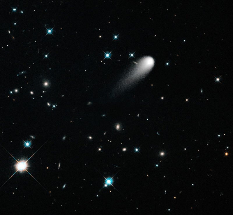 In this Hubble Space Telescope composite image taken in April 2013, the sun-approaching Comet ISON floats against a seemingly infinite backdrop of numerous galaxies and a handful of foreground stars. The icy visitor, with its long gossamer tail, appears to be swimming like a tadpole through a deep pond of celestial wonders. In this composite image, background stars and galaxies were separately photographed in red and yellow-green light. Because the comet moved between exposures relative to the background objects, its appearance was blurred. The blurred comet photo was replaced with a single, black-and-white exposure. The images were taken with the Wide Field Camera 3 on April 30, 2013. UPI/NASA
