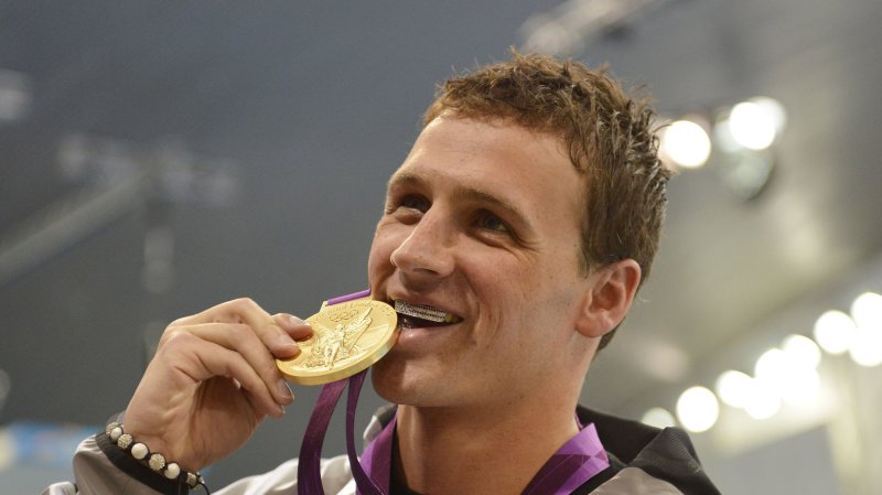 Ryan Lochte bites his gold medal after winning the men's 400M IM race at the London Olympics. UPI/Brian Kersey