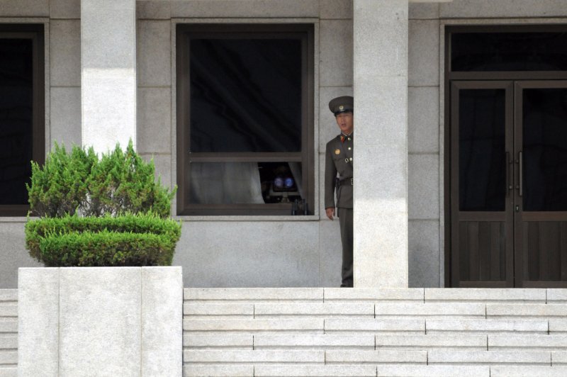 A North Korean soldier stands watch on the North Korean side of the Demilitarized Zone seen from Panmunjom, South Korea. North Korea said in a statement Monday that the South is "acting up" in order to realize its "impure ambition of stifling North Korea," a reference to Pyongyang's planned satellite launches. File Photo by Spike Call/US Navy