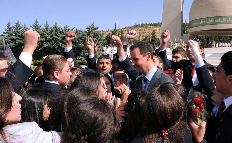 Syrian President Bashar al-Assad is greeted by children of soldiers during a ceremony to mark Martyrs' Day at the Tomb of the Unknown Soldier in Damascus May 6, 2011. UPI/Handout..