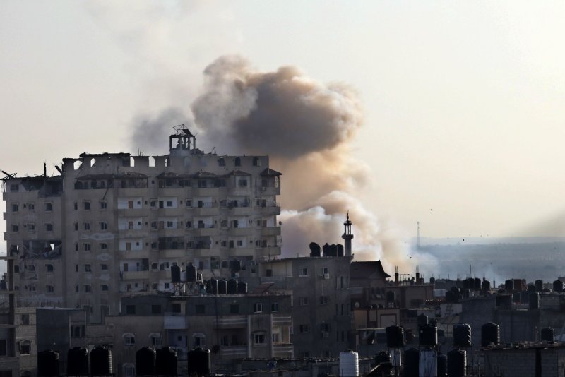 Smoke rises after the Israeli bombardment of Rafah in the southern Gaza Strip Friday. Israel said on Friday that its forces struck an ambulance convoy in southern Gaza and said it was being used by Hamas. Photo by Ismael Mohamad/UPI