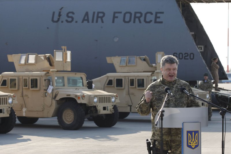 Ukrainian President Petro Poroshenko participate in a welcome ceremony for first U.S. air-force plane to Ukraine with non-lethal military equipment including ten Humvee vehicles in Kiev airport on March 25, 2015. Poroshenko was critical of the ceasefire in eastern Ukraine, saying peace was only possible after Russian troops leave. File Photo by UPI/Ivan Vakolenko.