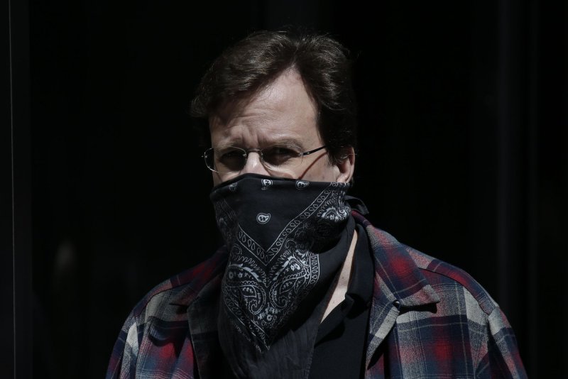 A pedestrian walks on Third Avenue wearing a face mask in New York City in April. File Photo by John Angelillo/UPI