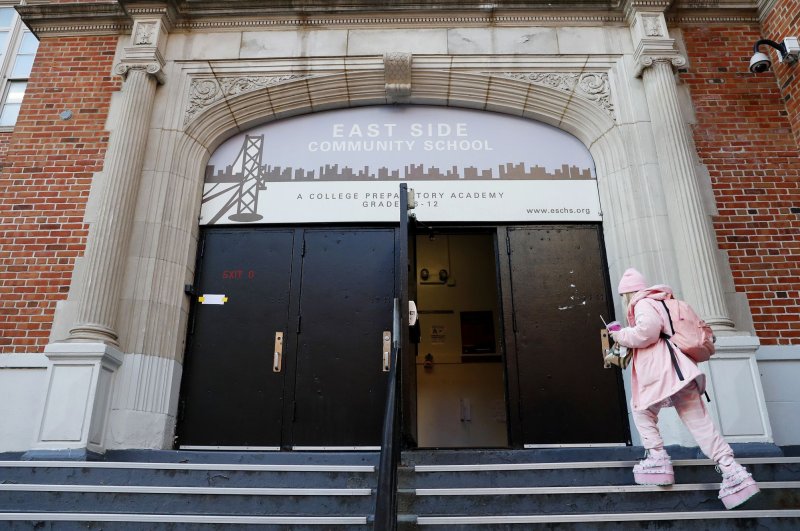Students wear masks when they enter the East Side Community High School in the East Village on Jan. 18, 2022, in New York City. File Photo by John Angelillo/UPI