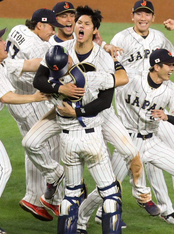Japan's Shohei Ohtani (C) celebrates with catcher Yuhei Nakamura and teammates after a 3-2 win over Team USA during the World Baseball Classic Final in Miami, Fla., on Tuesday. Photo by Aaron Josefczyk/UPI