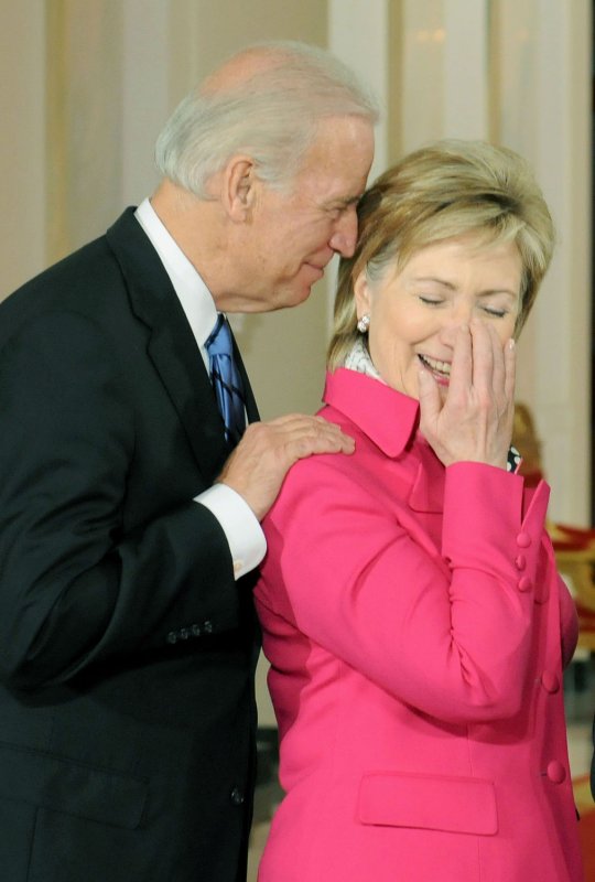 Vice President Joe Biden (L) speaks with then-Secretary of State Hillary Clinton during a signing ceremony for the Fair Pay Restoration Act at the White House in Washington on Jan. 29, 2009. Obama signed the Act which outlaws discrimination in wages based on sex. (UPI Photo/Kevin Dietsch)