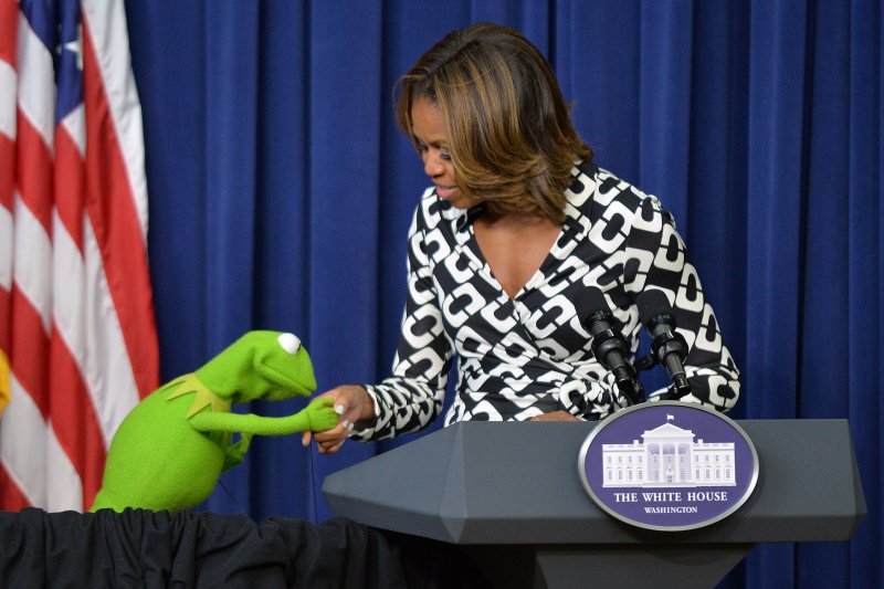 Kermit the Frog kisses First Lady Michelle Obama on the hand during a movie screening of "Muppets Most Wanted" for children of military families at the Eisenhower Executive Office Building in Washington, DC, on March 12, 2014. File Photo by Kevin Dietsch/UPI