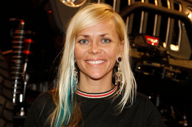 Jessi Combs takes a quick break from signing autographs to pose for a photo during the 2018 SEMA Show at the Las Vegas Convention Center on October 31. She died Tuesday at age 36. File Photo by James Atoa/UPI