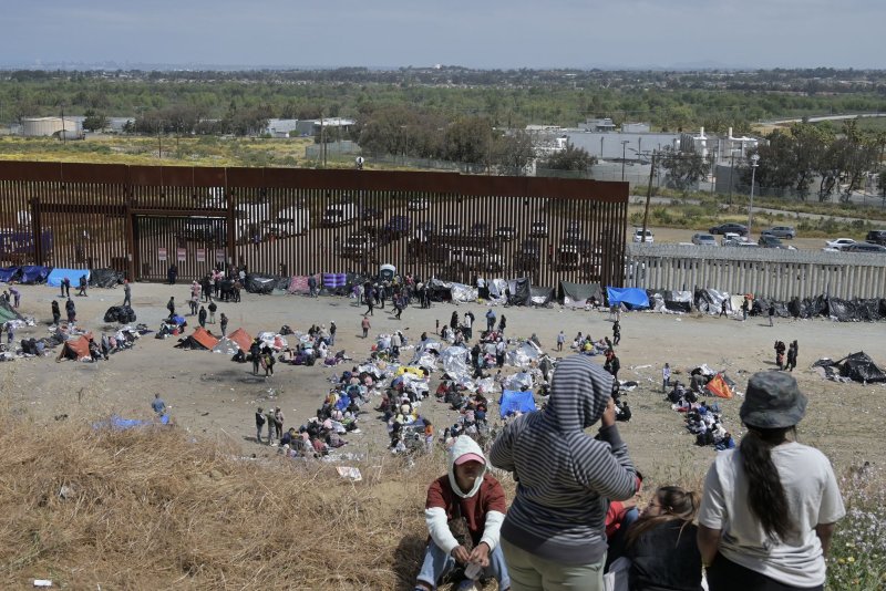 A 17-year-old Honduran migrant has died while in U.S. custody in Florida as thousands of migrants trying to enter the U.S. are stuck at the southern border. Pictured are migrants stuck between the primary and secondary fencing at the Tijuana-San Diego border as seen from Tijuana, Mexico, on Thursday. Photo by Carlos Moreno/UPI