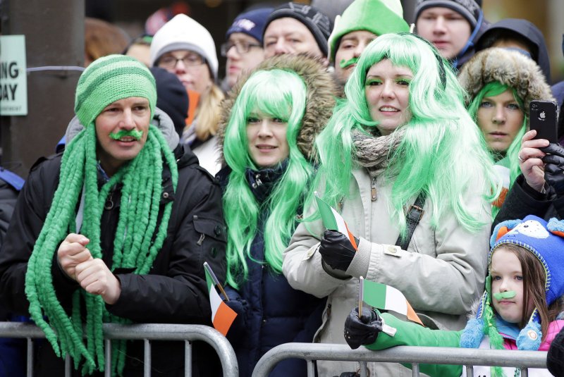 Crowds of people gather to watch the St. Patrick's Day Parade on Fifth Avenue in New York City on March 17, 2014. The parade stepped off Monday without Mayor Bill de Blasio marching along with the crowds of kilted Irish Americans and bagpipers amid a dispute over whether participants can carry pro-gay signs. UPI/John Angelillo