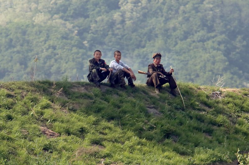 North Korean soldiers sit in the shade near the North Korean city Sinuiju, across the Yalu River from Dandong, China's largest border city with North Korea. South Korean analysts said Thursday Seoul should be prepared if the United States and North Korea decide to talk ahead of Pyongyang’s commitment to denuclearization. File Photo by Stephen Shaver/UPI