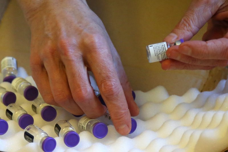 A medical worker handles vials of the Pfizer COVID-19 vaccine at a facility in Paris, France, on Monday. Photo by David Silpa/UPI