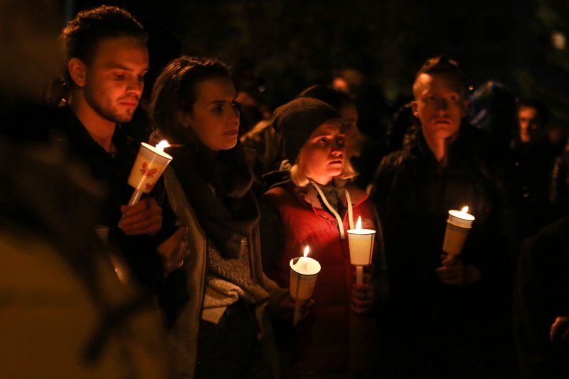 Participants hold candles at a vigil December 5, 2016, by Oakland's Lake Merritt for victims of the Ghost Ship fire in Oakland, Calif., on December 2, 2016. File Photo by Khaled Sayed/UPI