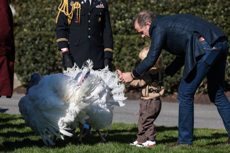 Hunter Biden carries Beau Biden to an event where President Joe Biden will pardon The National Thanksgiving Turkeys on Monday on the South Lawn of the White House. The two turkeys are from North Carolina and their names are Chocolate and Chip. Photo by Oliver Contreras/UPI | <a href="/News_Photos/lp/ee373a420821d4d7a265002ffb297fda/" target="_blank">License Photo</a>